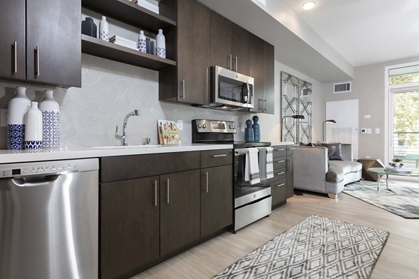 Modern kitchen with stainless steel appliances at Baxter on Broadway Apartments