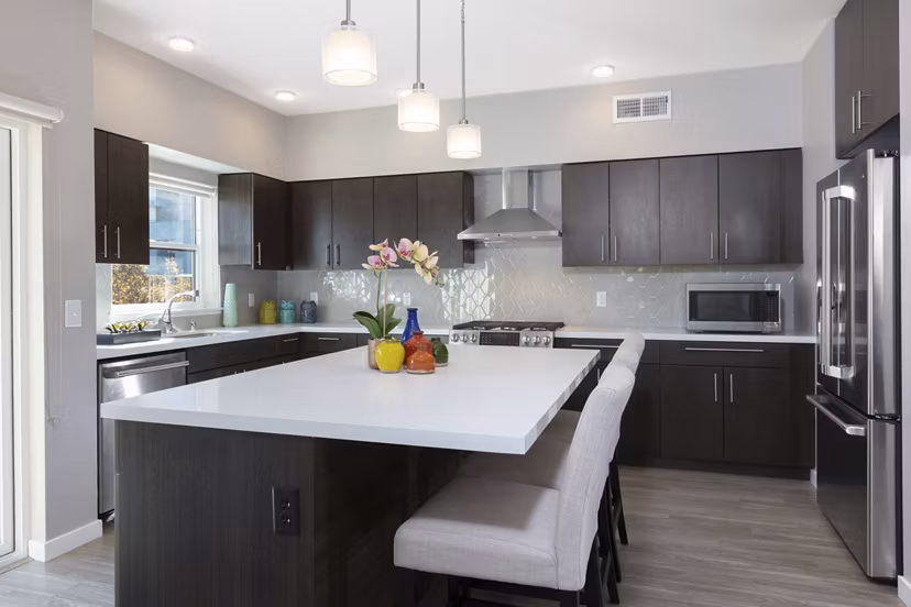 Modern kitchen with stainless steel appliances at Baxter on Broadway Apartments