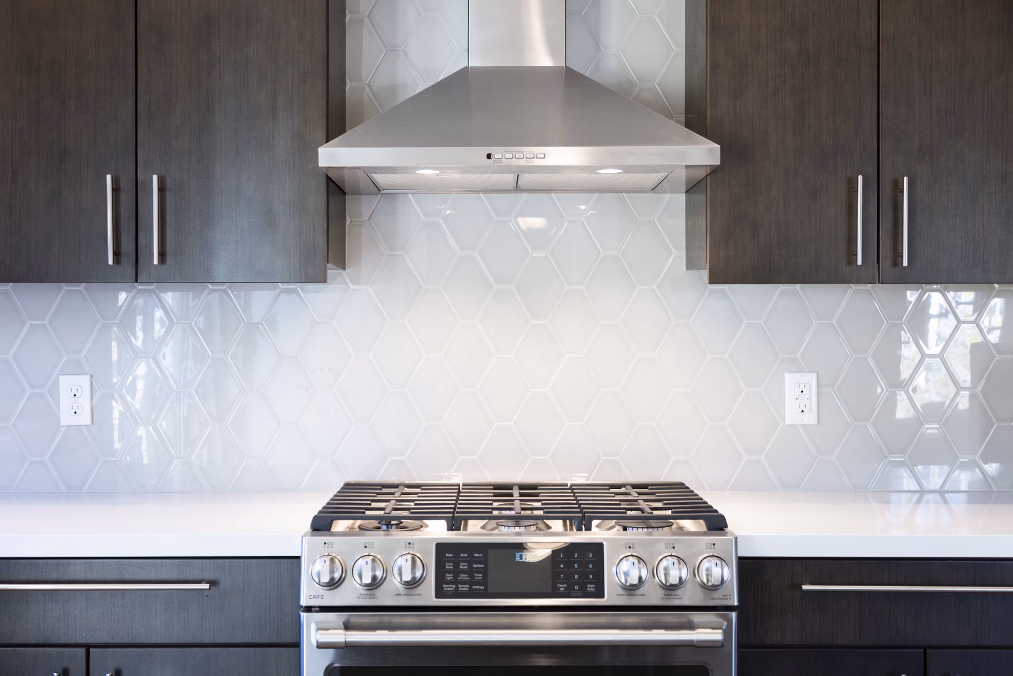 Modern kitchen with stainless steel appliances and island at Baxter on Broadway Apartments