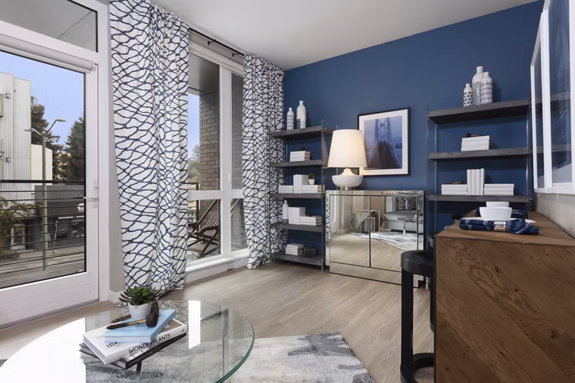 Modern living room with stylish decor and ample natural light at Baxter on Broadway Apartments