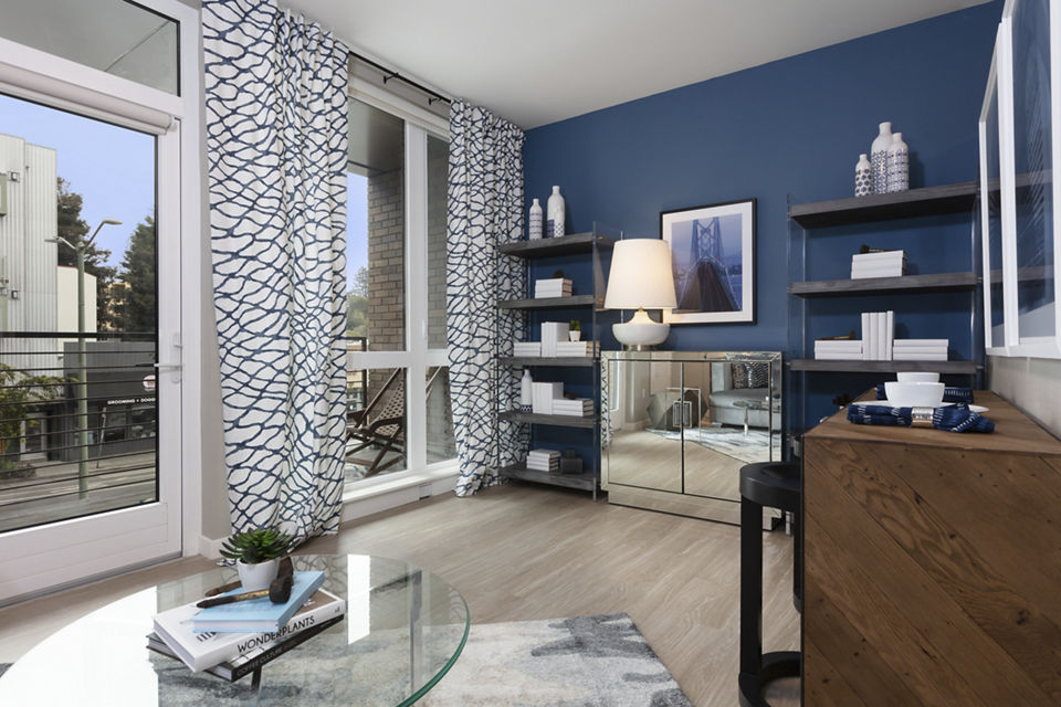 Modern living room with stylish decor and ample natural light at Baxter on Broadway Apartments