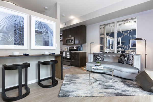 Spacious living room with modern furnishings at Baxter on Broadway Apartments in Oakland, perfect for luxury apartment living