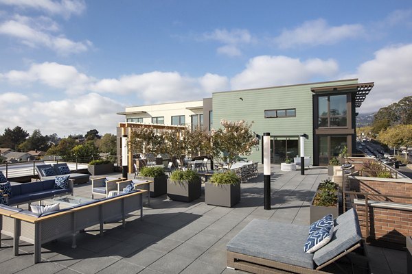 Rooftop deck with seating at Baxter on Broadway Apartments in Oakland