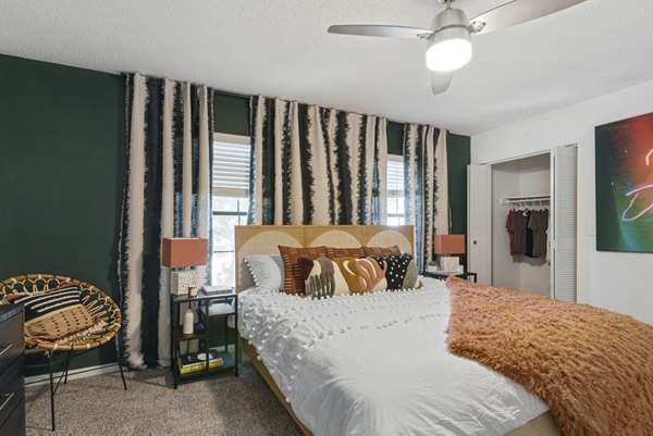 Cozy bedroom with modern furnishings in Aventura Bellevue Apartments