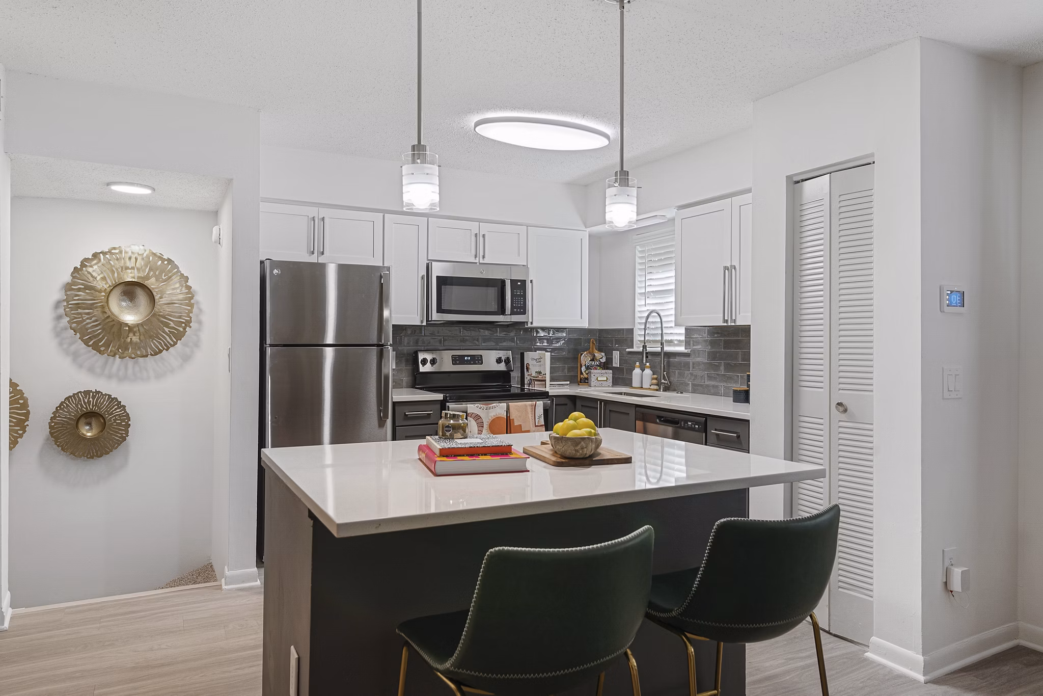 Modern kitchen with stainless steel appliances at Aventura Bellevue Apartments
