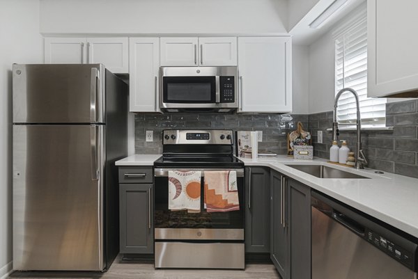 Modern kitchen with stainless steel appliances at Aventura Bellevue Apartments