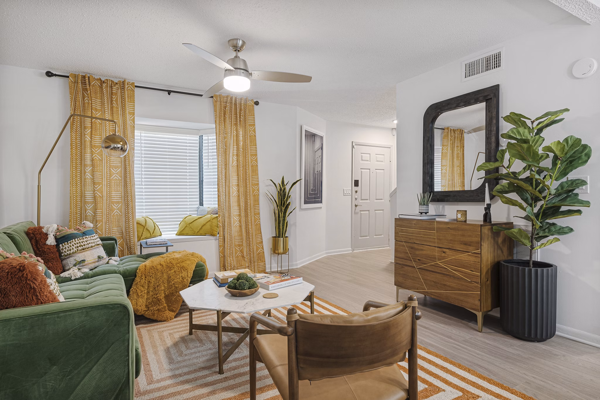 Spacious living room with modern decor and glass doors in Aventura Bellevue Apartments