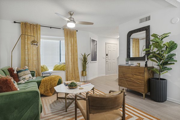 Spacious living room with modern decor and glass doors in Aventura Bellevue Apartments