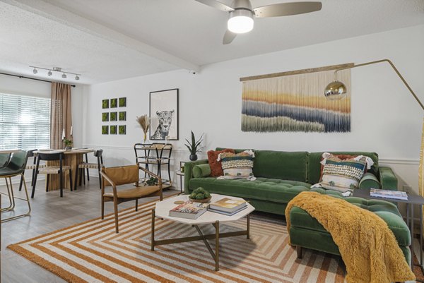 Spacious living room with modern decor in Aventura Bellevue Apartments, featuring elegant furnishings and large windows