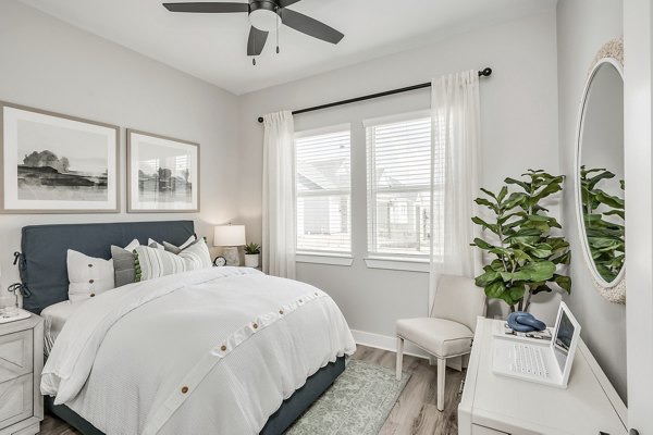 Cozy bedroom with modern decor at Wingspan at Bridgeland luxury apartments