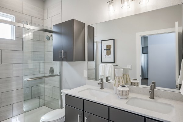 Luxurious bathroom featuring modern fixtures at Wingspan at Bridgeland Apartments