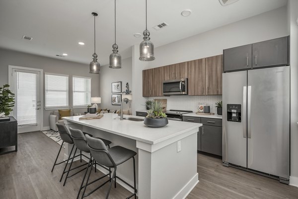 Modern kitchen with stainless steel appliances at Wingspan at Bridgeland Apartments