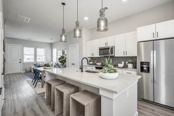 Sleek modern kitchen with stainless steel appliances at Wingspan at Bridgeland Apartments