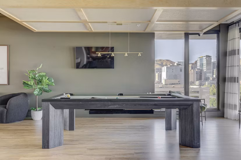 Vibrant game room with pool table and lounge seating at Lattice Apartments, perfect for social gatherings and entertainment