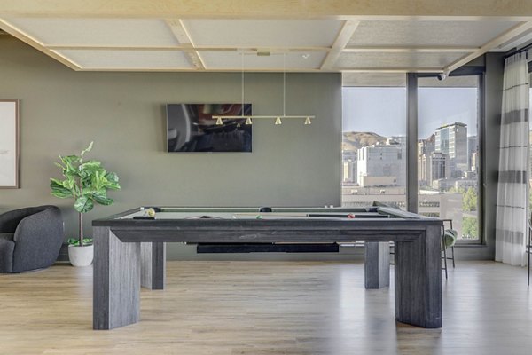 Vibrant game room with pool table and lounge seating at Lattice Apartments, perfect for social gatherings and entertainment