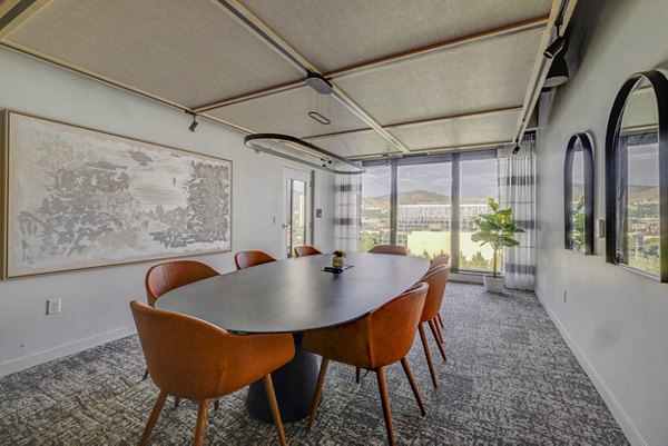 Meeting room with modern seating and AV equipment at Lattice Apartments