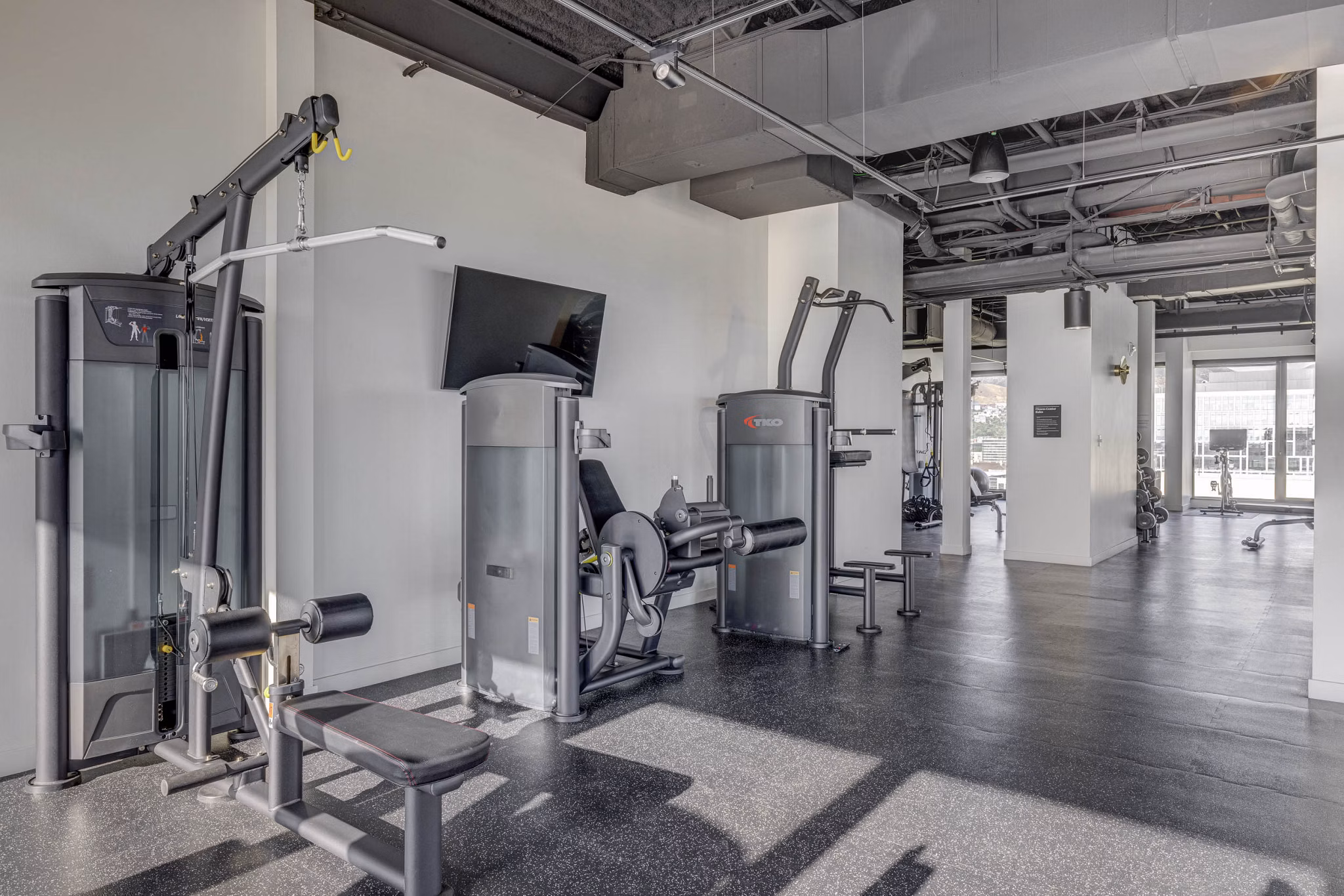 Fitness center with state-of-the-art equipment at Lattice Apartments, offering luxury amenities for residents seeking an active lifestyle