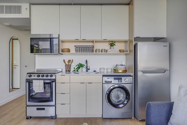 Contemporary kitchen with stainless steel appliances in Lattice Apartments