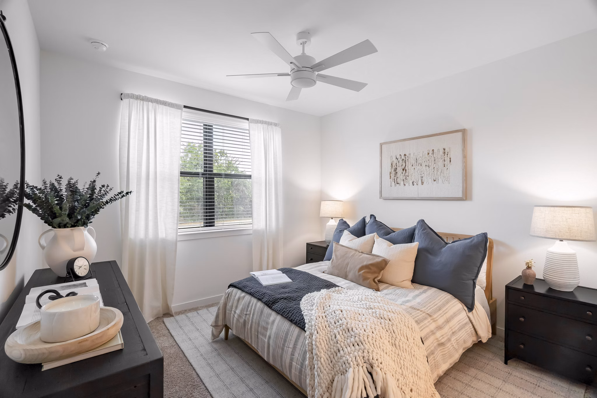 Cozy bedroom with modern decor at Citizen House Bergstrom Apartments offering luxury living options