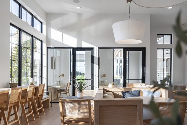 Clubhouse featuring modern design and communal seating at Citizen House Bergstrom Apartments