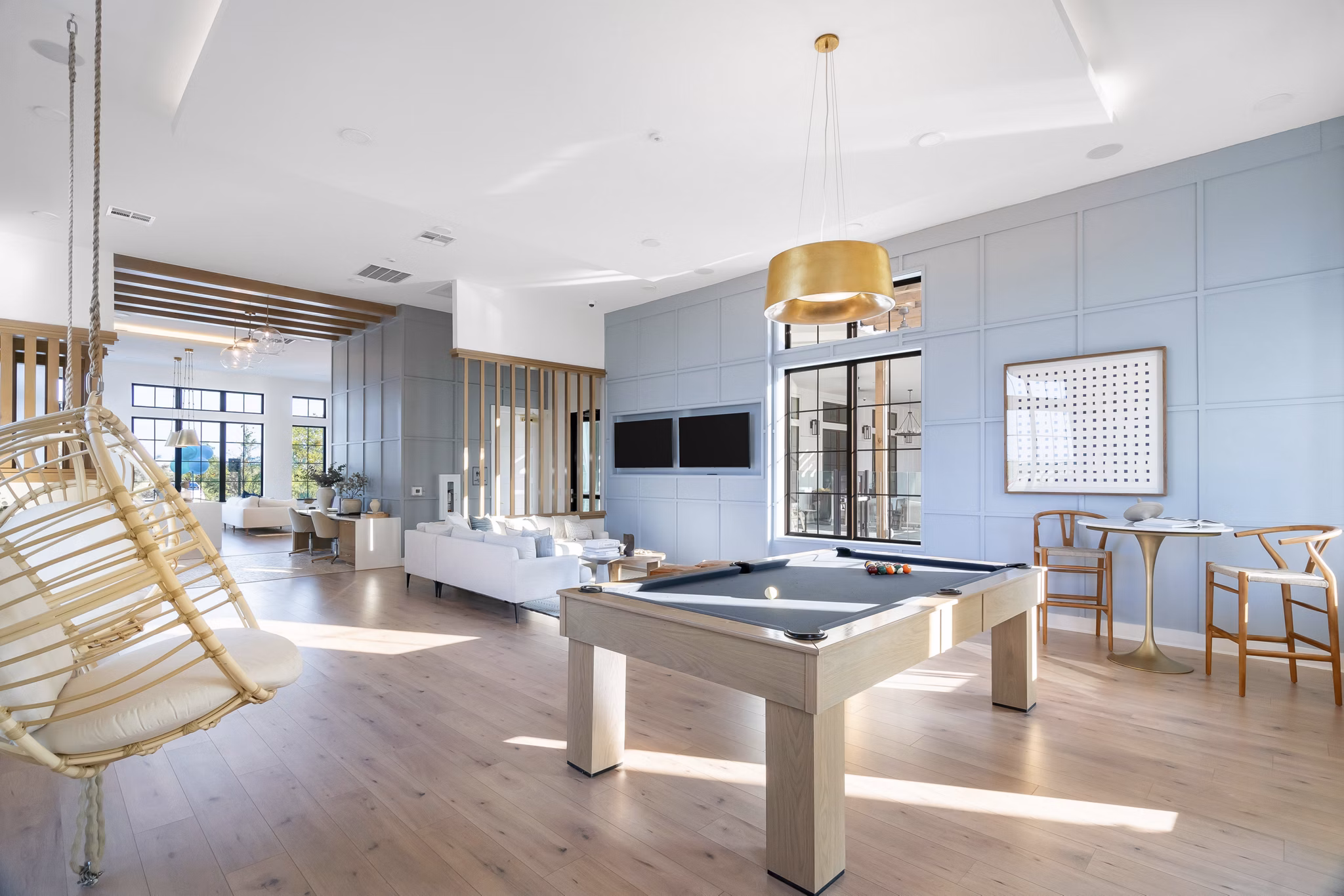 Vibrant game room with pool table and seating at Citizen House Bergstrom Apartments