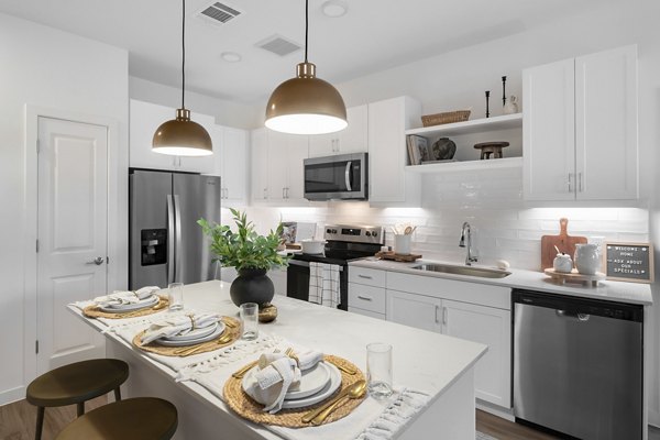 Modern kitchen with stainless steel appliances at Citizen House Bergstrom luxury apartments