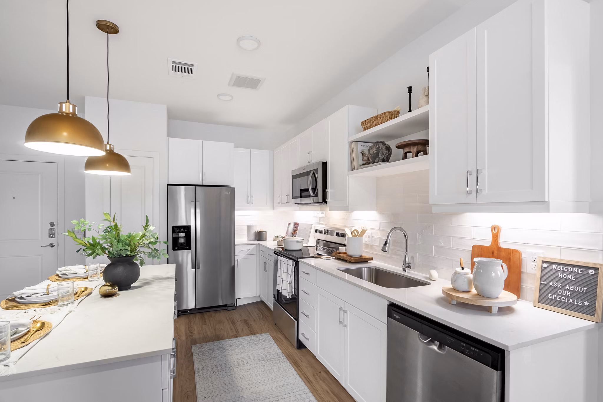 Modern kitchen with stainless steel appliances in Citizen House Bergstrom Apartments