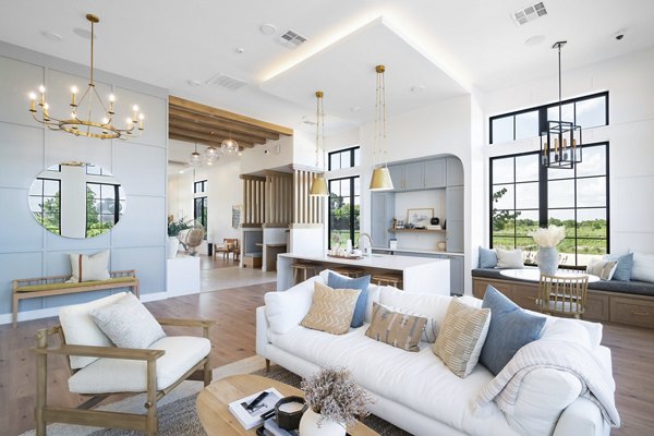 Spacious living room featuring modern decor and large windows at Citizen House Bergstrom Apartments, offering luxurious living spaces