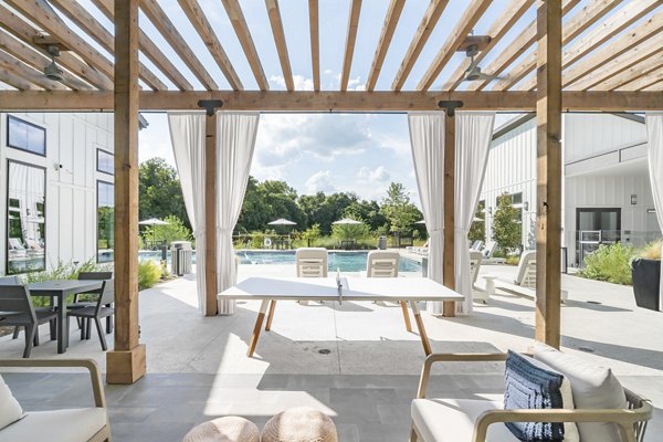 Private patio with modern furniture at Citizen House Bergstrom Apartments, perfect for relaxation and outdoor dining