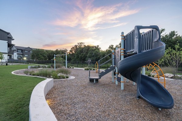 Colorful playground equipment at Citizen House Bergstrom Apartments playground, ideal for family-friendly living in luxury Austin community