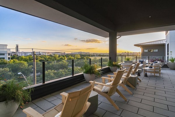 Private balcony with cityscape view at Solomon Apartments, offering a luxurious living experience in an urban setting