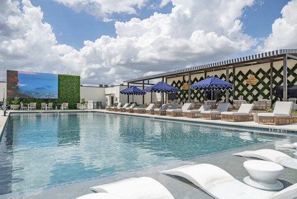 Outdoor pool area with lounge seating at Solomon Apartments, a Greystar luxury property