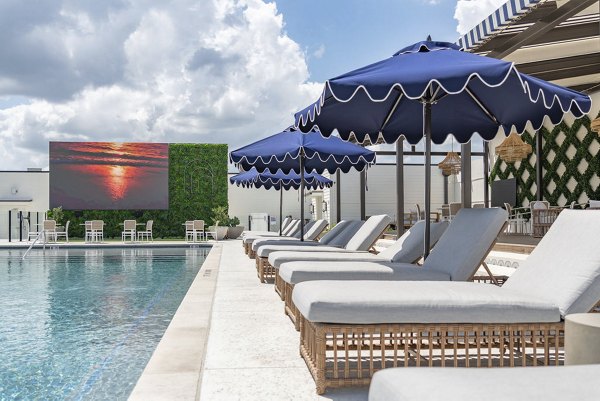 Relaxing pool area with lounge chairs at Solomon Apartments