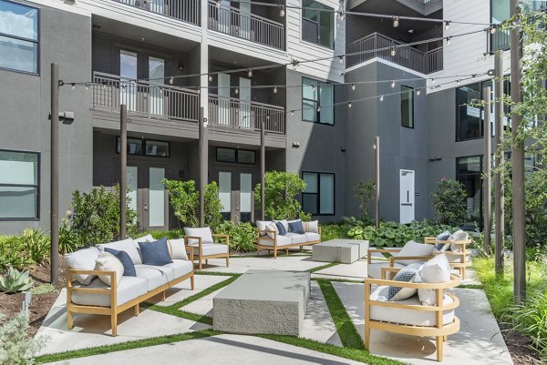 Spacious recreational area with modern seating and bright lighting at Solomon Apartments, ideal for relaxation and social gatherings
