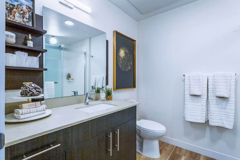 Luxurious bathroom featuring marble countertops and modern fixtures at Markana Uptown Apartments