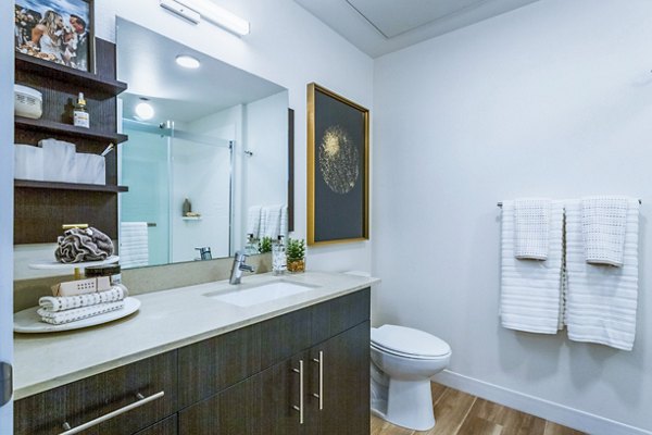 Luxurious bathroom featuring marble countertops and modern fixtures at Markana Uptown Apartments