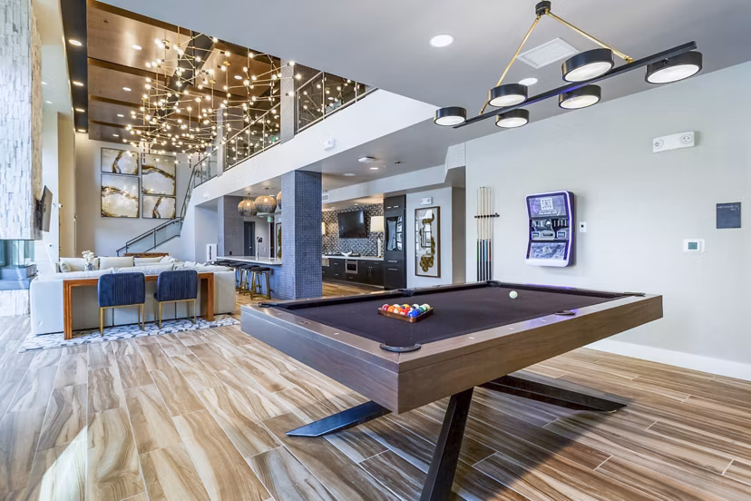 Modern clubhouse game room with pool table and seating area at Markana Uptown Apartments, offering luxury living in the heart of the city
