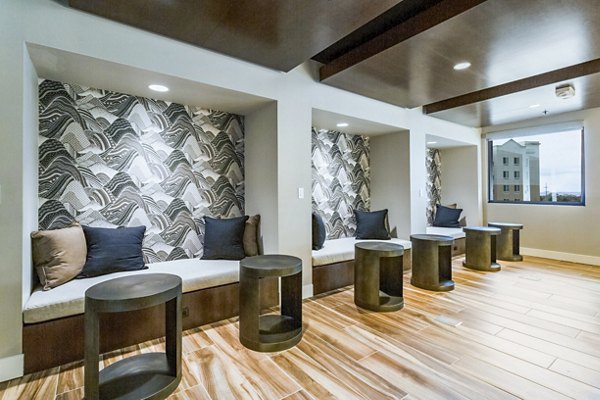 Elegant clubhouse with modern decor at Markana Uptown Apartments, offering a luxurious space for residents to gather and relax