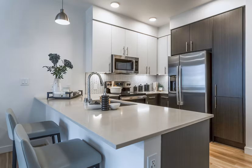 Modern kitchen with stainless steel appliances at Markana Uptown luxury apartments