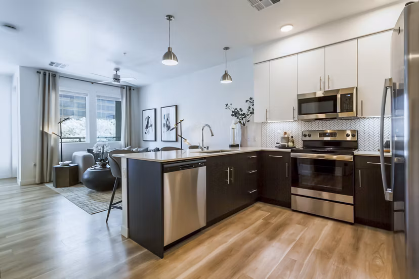 Modern kitchen with stainless steel appliances at Markana Uptown Apartments luxury community
