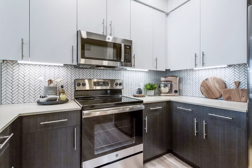 Modern kitchen with sleek countertops and stainless steel appliances at Markana Uptown Apartments