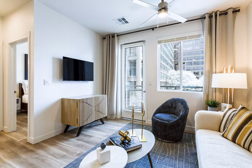 Spacious living room with modern furniture at Markana Uptown Apartments