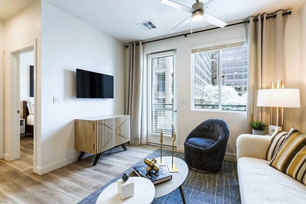 Spacious living room with modern furniture at Markana Uptown Apartments