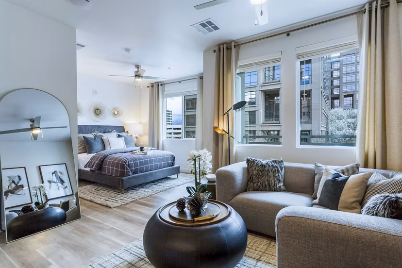 Modern living room with stylish furniture and large windows at Markana Uptown Apartments, offering luxury living experiences