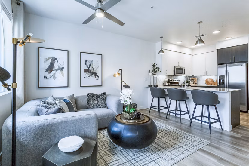 Stylish living room with modern furnishings and large windows at Markana Uptown Apartments offering luxury living in a vibrant community