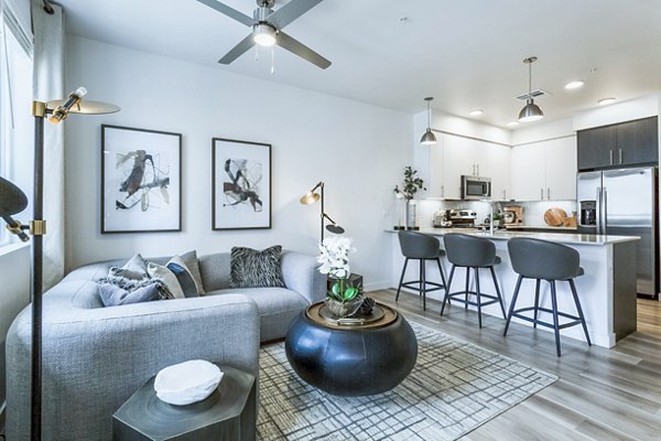 Stylish living room with modern furnishings and large windows at Markana Uptown Apartments offering luxury living in a vibrant community