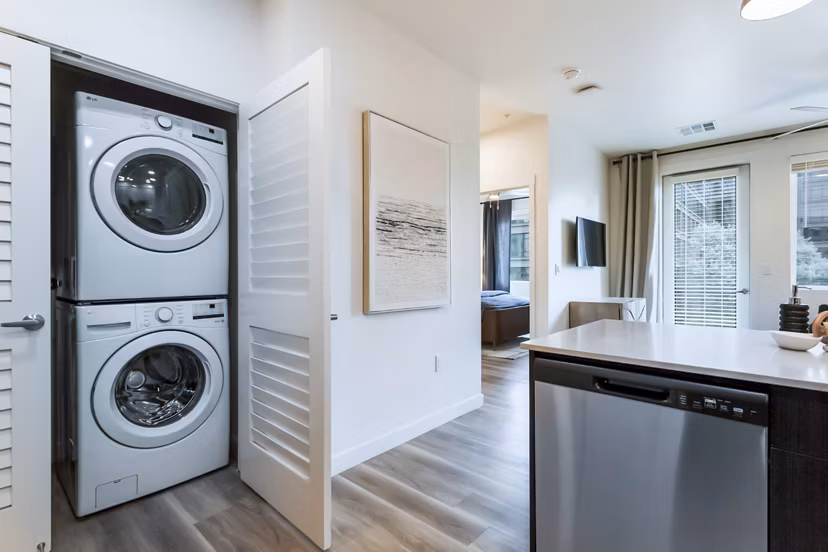 Laundry and kitchen with modern appliances in Markana Uptown Apartments