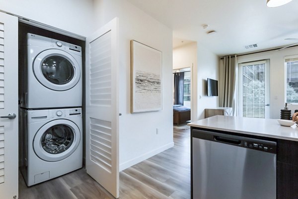 Laundry and kitchen with modern appliances in Markana Uptown Apartments
