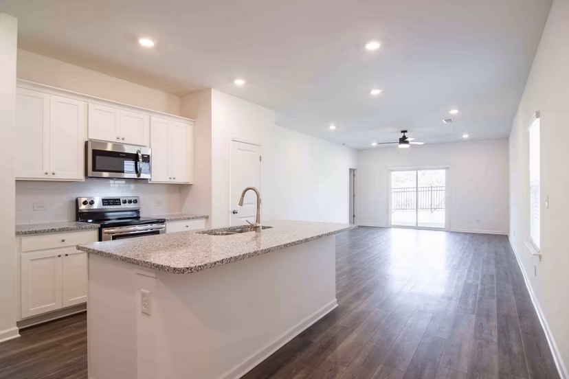 Modern kitchen with stainless steel appliances at Summerwell Deerhaven Apartments