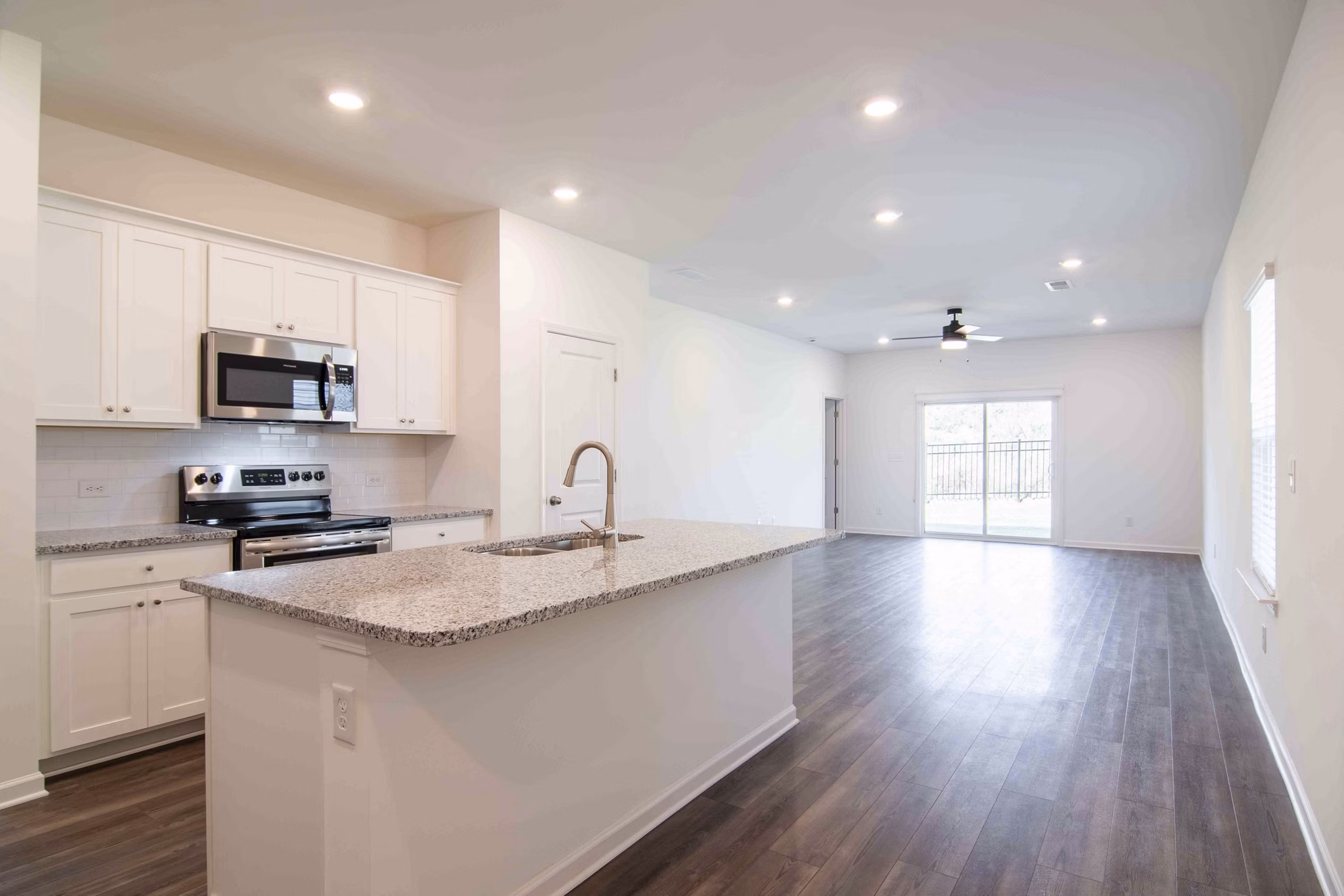 Modern kitchen with stainless steel appliances at Summerwell Deerhaven Apartments
